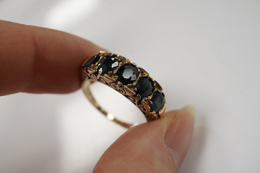 A 1970's Victorian style 9ct gold and graduated five stone sapphire set half hoop ring, size Q, gross weight 5.6 grams. Condition - fair to good